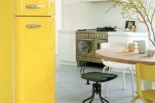 06 cheer up a neutral and peaceful kitchen with a sunny yellow Smeg fridge and a matching chair