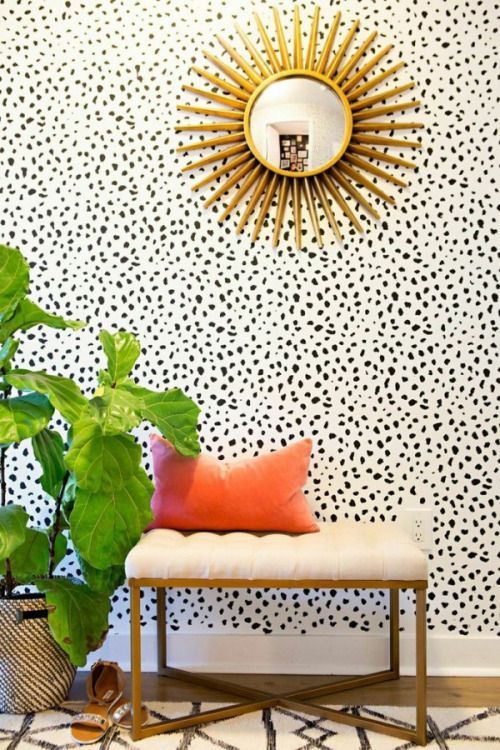 dalmatian print wallpaper makes this entryway eye-catchy and brass accents add glam