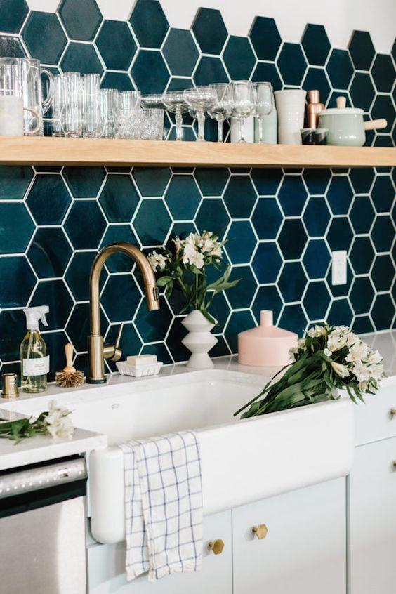 glossy emerald hexagon tiles, brass touches and wood make the kithen super chic