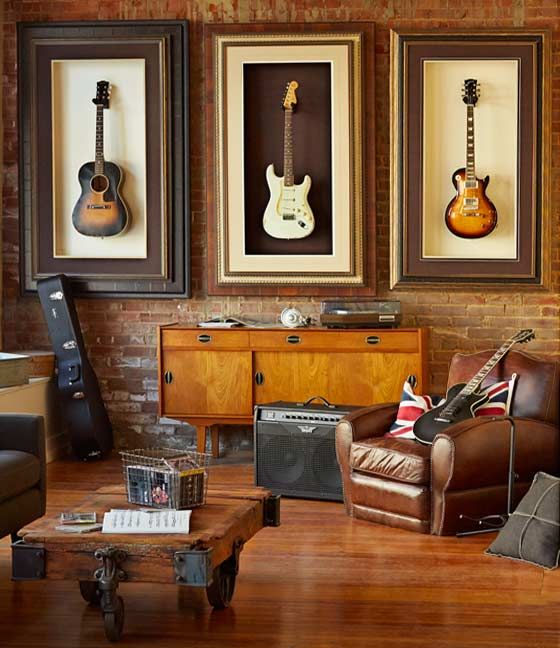 a chic modern space with an industrial feel, guitars displayed on the wall and leather furniture