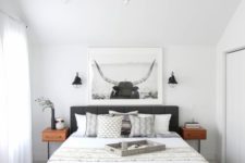 07 a modern black chandelier and small black sconces for a stylish modern bedroom