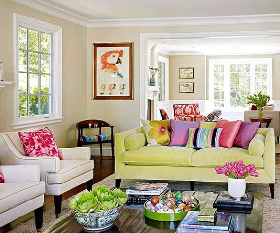 a neon yellow sofa adds color to this neutral living room and so do colorful pillows