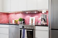 07 a neutral kitchen was turned into a feminine space with glossy pink tiles on the backsplash
