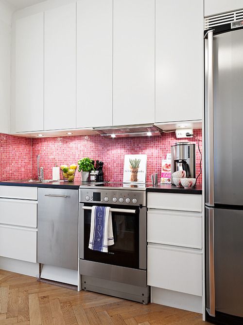 a neutral kitchen was turned into a feminine space with glossy pink tiles on the backsplash