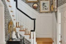 07 zebra print wallpaper for a glam and refined entryway and a warm-colored stair runner