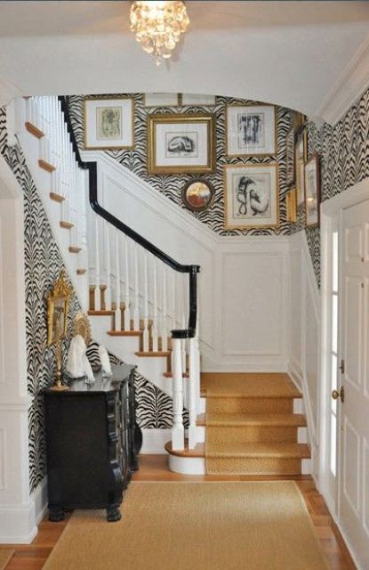 Zebra print wallpaper for a glam and refined entryway and a warm colored stair runner