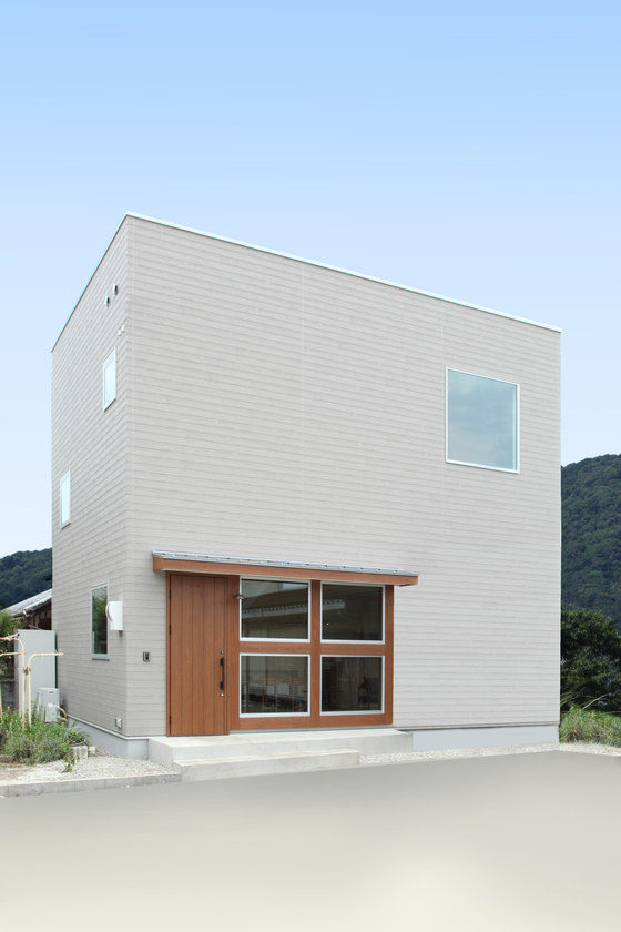 The house has a relatively small footprint, it's clad in white and there are lots of windows spotted here and there