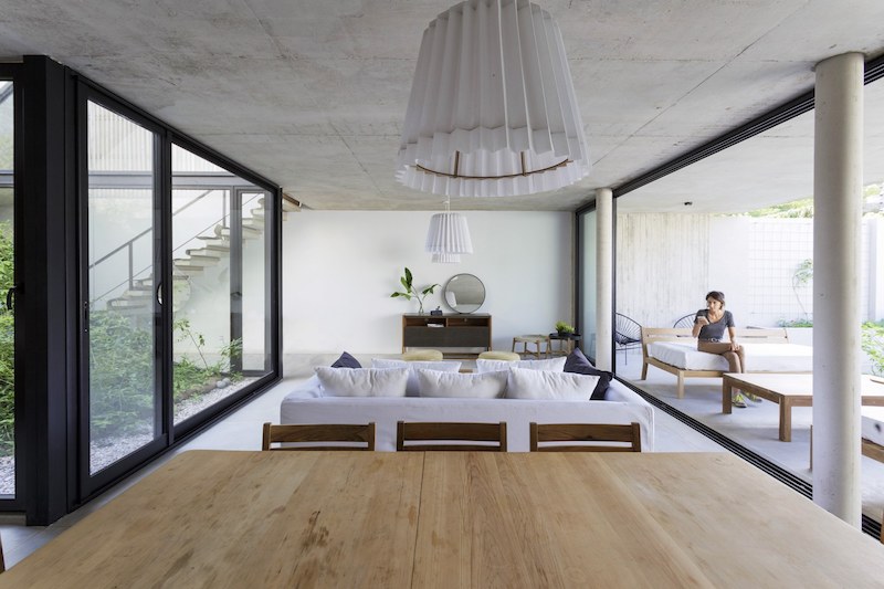 The living area is squeezed between the interior garden and a covered outdoor lounge space