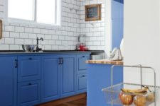 08 a bold blue kitchen with white subway tiles and black grout to stand out