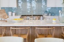 08 a seaside kitchen is made up using matte white cabinets and a glossy blue tile backsplash