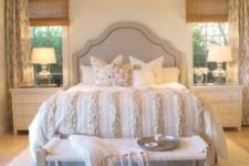 09 a cozy neutral bedroom with a large chandelier and bedside lamps that fit the look of the room