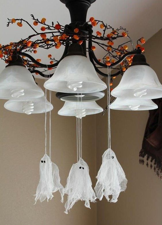 attach small cheesecloth ghosts to the chandelier to give your home a Halloween feel