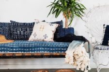 09 shibori pillows and an upholstered bench add to the look of this boho inspired space
