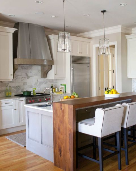 the kitchen island fits kitchen decor, and a wood countertop on it fits the space around it