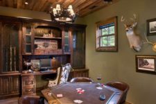 10 a rustic man cave with taxidermy, leather chairs, antlers and wooden furniture