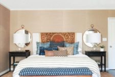 10 shibori pillows and an upholstered bench for a trendy feel in the bedroom