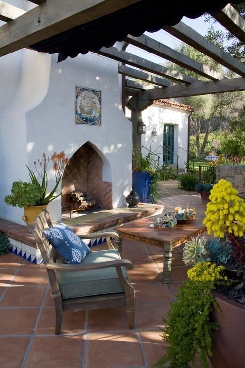 the terrace is done with a white hearth decorated with azulejo tiles and rough wood furniture
