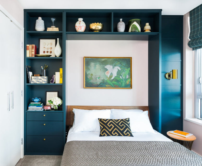The guest bedroom is also done with a navy shelving unit around the bed