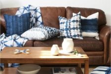 11 a brown leather sofa looks refreshed and more eye-catchy with shibori pillows and a blanket