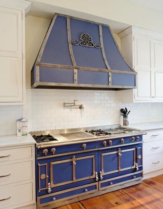 a beautiful retro blue kitchen stove with a hood and stainless steel fittings