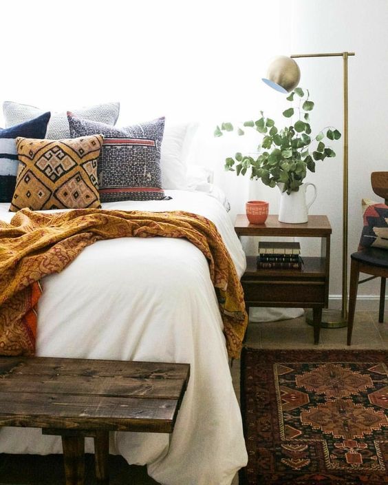 a comfy printed blanket and a neutral bed cover will make your guest feel comfy even if it's cold
