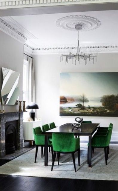 a cozy neutral dining room with bold emerald upholstered chairs that make a statement
