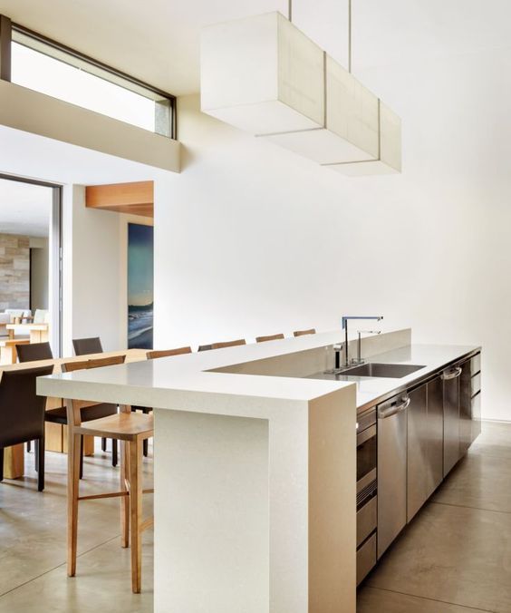 a modern space with a minimalist feel is completed with a sleek white countertop