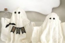 12 small cheesecloth ghosts with eyes, a banner and a faux bat for mantel decor