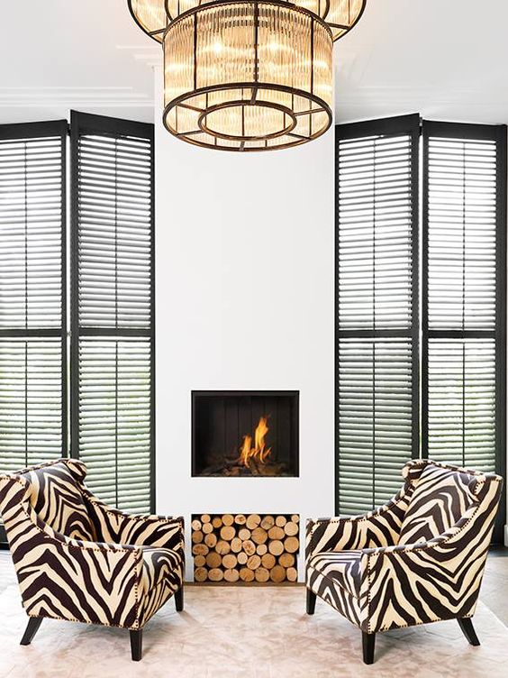 zebra print chairs add interest to a neutral fireplace space