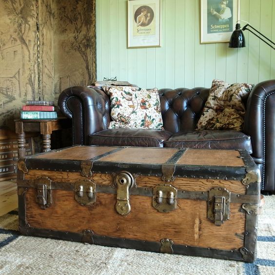 a vintage wooden trunk accentuates this living room and doubles as a coffee table and a storage
