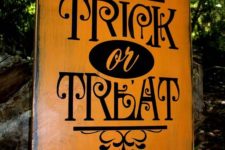 13 an elegant orange and black TRICK OR TREAT sign with pretty patterns
