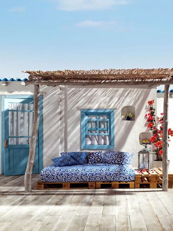pallet furniture with blue printed upholstery and pillows is cool for the terrace