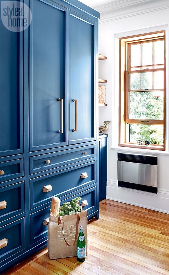 Parisian bistro-inspired kitchen with vibrant blue cabinets