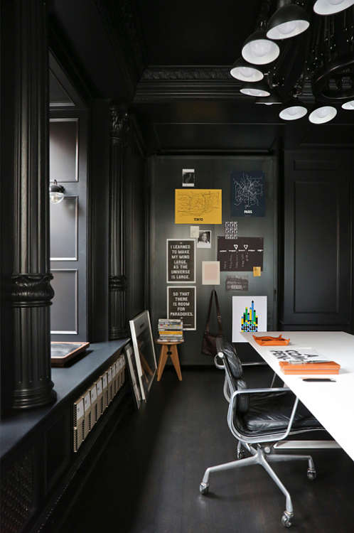 There's also a home office done in black with colorful details that enliven the space