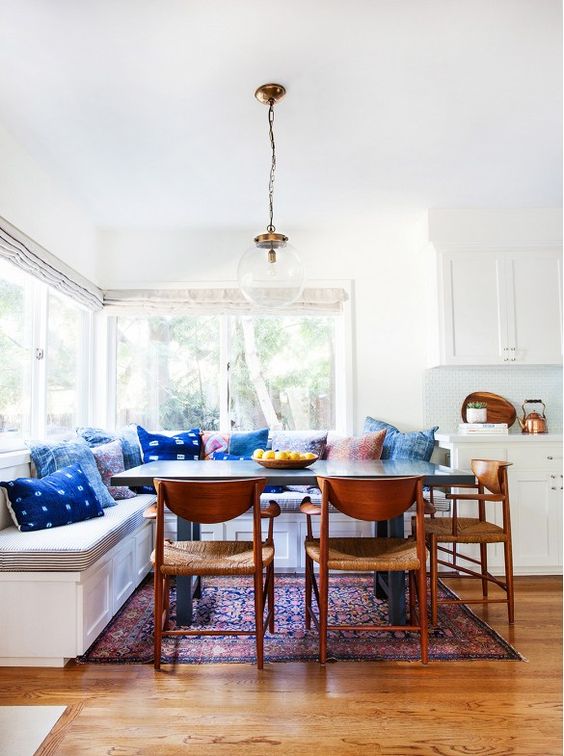 a dining zone spruced up with colorful pillows including shibori ones