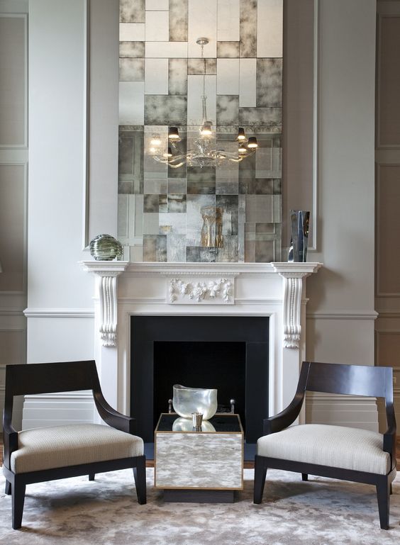 a white vintage fireplace with black inside and firewood on a metal stand just for display