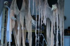 14 dark-colored cheesecloth ghosts with a lantern will find a way to your outdoor space
