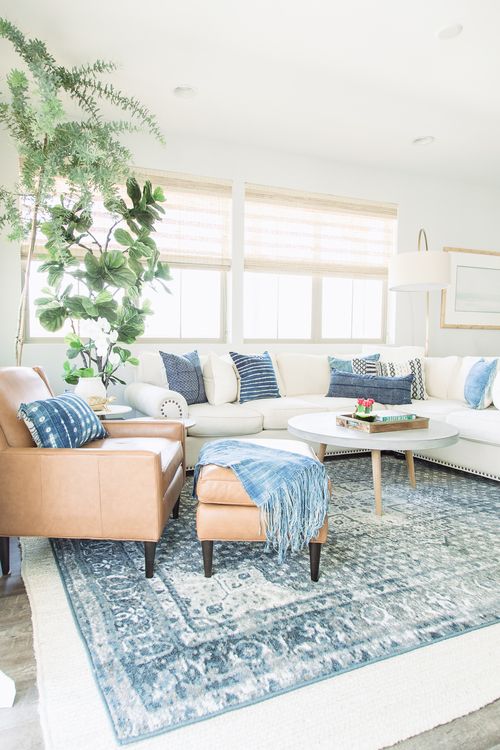 a large white sectional sofa is made trendier with shibori pillows