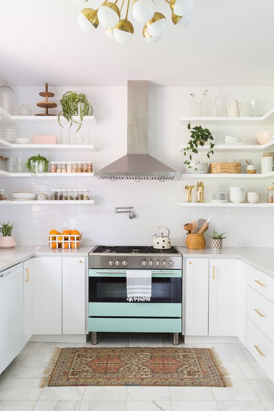 a mint colored cooker makes a soft colorful statement in this neutral space