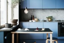 15 muted blue modern kitchen with a marble backsplash and sleek cabinets