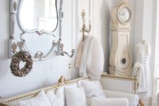 16 a luxurious interior in white, pastels and gold, with an antique mirror and clock