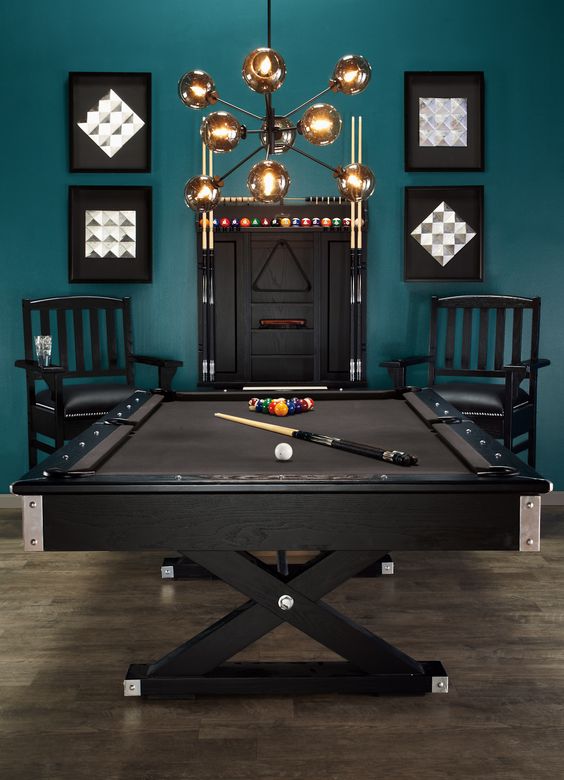 a stylish teal and black game room with a trestle pool table looks wow