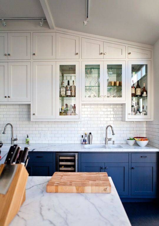 suspended white cabinets and cobalt blue ones on the floor create a light airy look