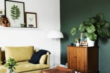 17 a dark green statement wall and a yellow sofa look organic and chic together