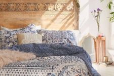 18 a carved wood bed with blue printed bedding is perfect for a Mediterranean feel in your bedroom