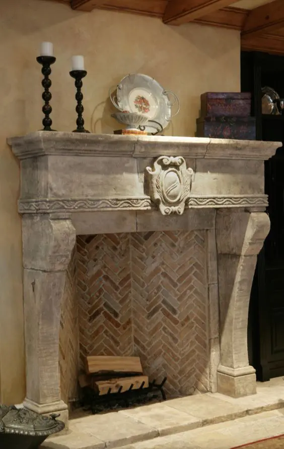 a stone fireplace with bricks inside and a metal stand with firewood