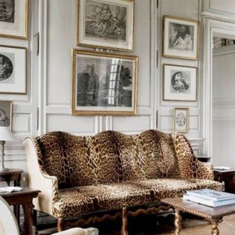 panelling, a gallery wall and a refined cheetah print sofa look very traditional and chic