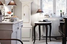 19 a Scandinavian kitchen with a white and gold grandfather’s clock and whitewashed furniture