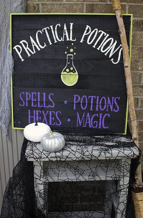a black pallet sign with purple and white letters and a fun potion bottle