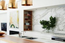 19 a marble kitchen island is completed with a wooden countertop and a couple of black leather stools